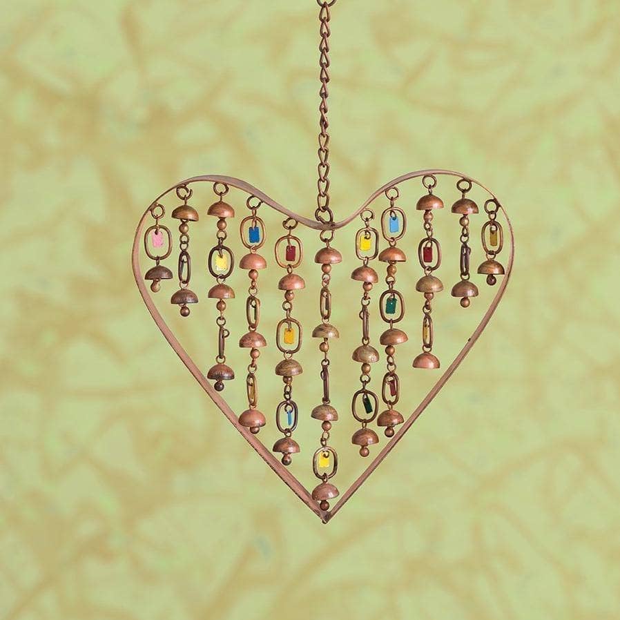 Brass heart-shaped wind chime with dangling bells and colorful beads, hanging from a chain